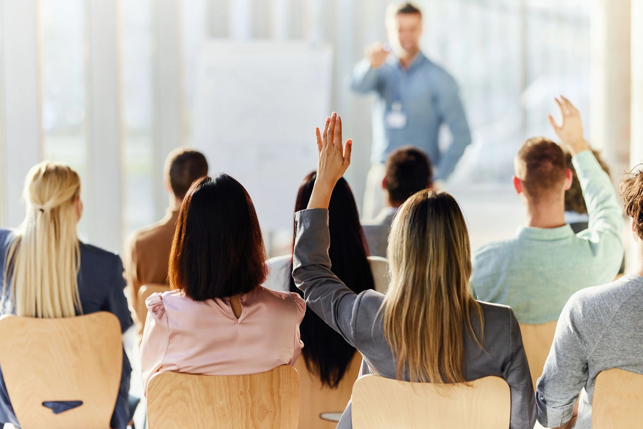 Participant raising a hand during a workshop session